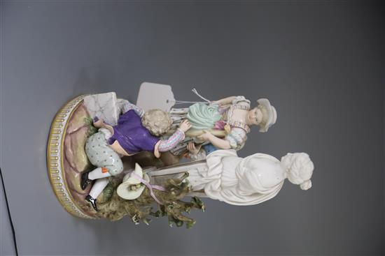 A Meissen group of children picking apples in a garden with a classical statue, late 19th century, H. 26.5cm